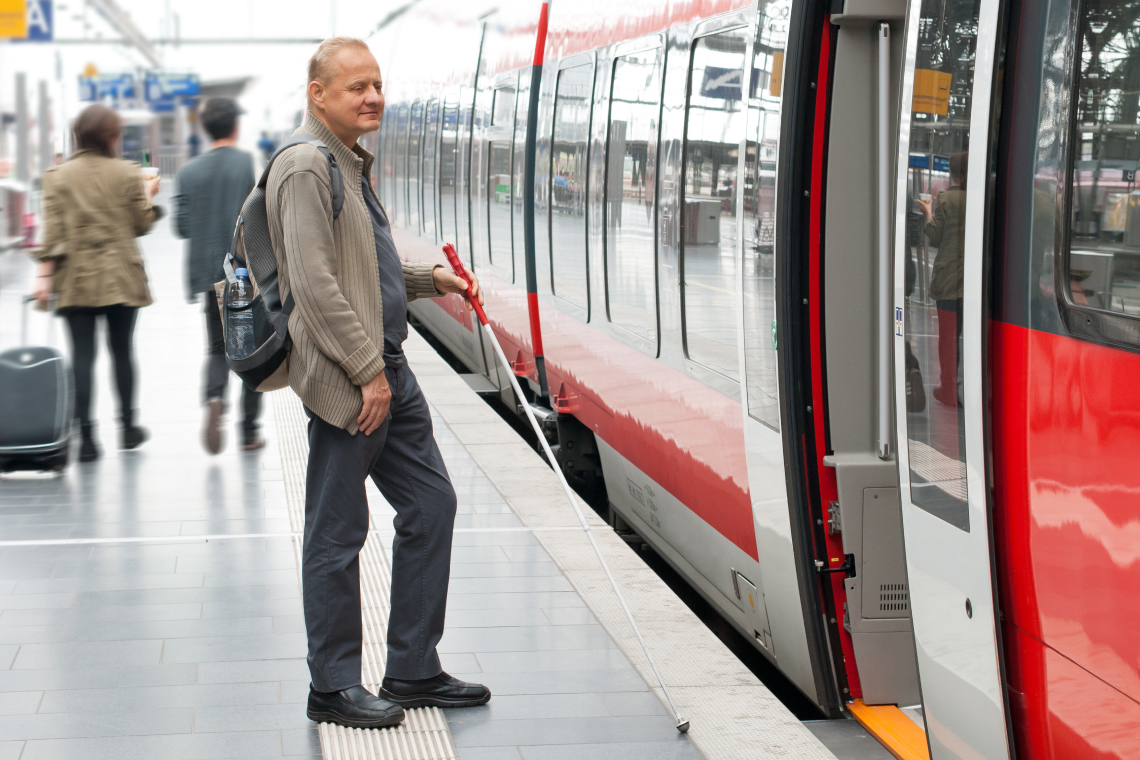 Blind person entering a train